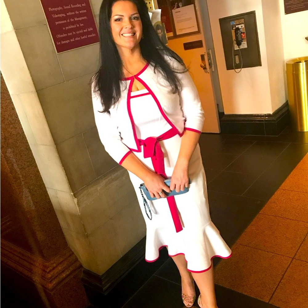 White strapless mermaid dress with hot pink trim and matching sweater.